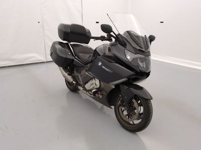 a black motorcycle parked in a room with a white wall
