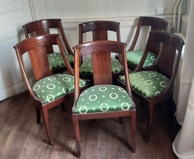 four chairs that are sitting in the corner of a room