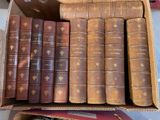 a box full of old books sitting on a table