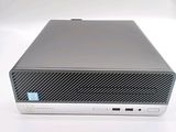 an image of a small computer on a white surface with a blue sticker on top of it