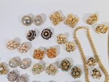 many different types of jewelry on a white surface