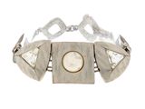 a close up of a bracelet with a face on it