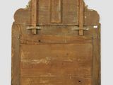 an old wooden mirror with a wooden frame on a white wall