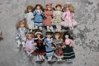 a lot of dolls that are sitting on the floor