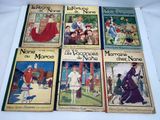 six children ' s books in french and english are on a white surface