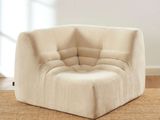 an image of a beige chair sitting on top of a rug