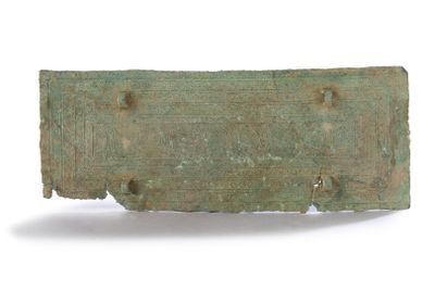 an old bronze plaque with holes in it on a white surface