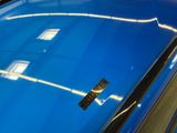 a reflection of a building in the windshield of a car