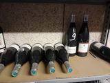 bottles of wine are lined up on a shelf in a wine cellar