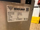 a machine that is sitting on the floor next to a yellow bin