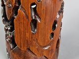 a wooden cup that has a carved design on it