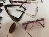 several pairs of sunglasses are lined up on a table