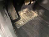 a close up of a car ' s floor mat with a pair of shoes on it
