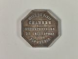 a silver coin with a picture of a man on it