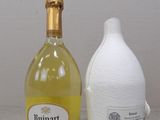 a bottle of wine next to a bottle of wine on a table