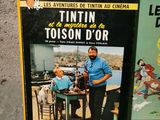 two books about tintin and toison d ' or on the floor
