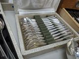 a lot of silverware in a box on a table