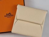 an orange box with a white wallet and a black box with a brown logo