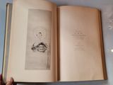 an open book with a picture of a person sitting on a boat in the water