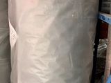 two large rolls of fabric sitting on a pallet in a warehouse