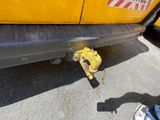 a yellow fire hydrant that is on the side of a truck