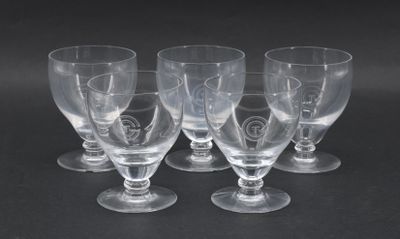 six clear wine glasses sitting on top of each other on a black surface