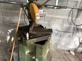 a machine that is sitting in a garage next to a trash can