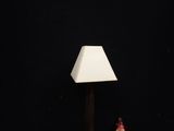 a lamp that is sitting on a table next to a cupcake