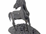 statue of a horse standing on a rock on a white background