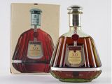 a bottle of brandy in front of a box