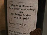a bottle of wine with a wax stamp on it