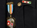 a close up of a military uniform with a medal on it