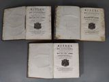 three old books sitting on top of a table next to each other