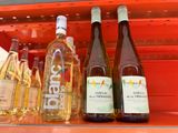 several bottles of wine are on a shelf in a store