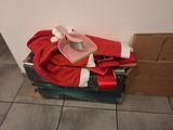 a pile of clothes and a hat on top of a suitcase