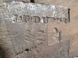 a close up of a piece of wood that has a sign on it