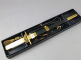 a black box with a knife and a rope in it