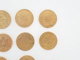 six different types of coins are shown on a white surface