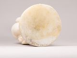a white vase sitting on top of a white table