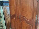 a large wooden armoire in the middle of a room
