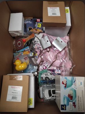 a cardboard box filled with assorted items and a rubber duck