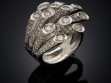 a close up of a diamond ring on a black surface