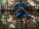 a picture of a stained glass window in a stone wall