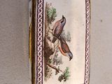 a small box with a picture of two birds on it