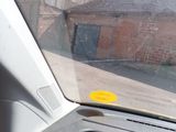 a yellow sticker on the dashboard of a car