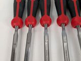 six red and black screwdrivers sitting next to each other on a white surface