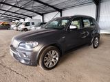 a picture of a bmw suv parked in a garage