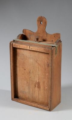 an old wooden box with a piece of wood sticking out of it