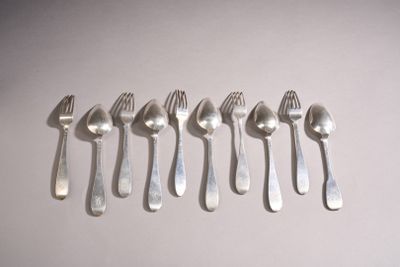 six forks and spoons are arranged in a row on a white surface