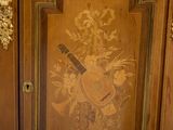 a wooden cabinet with a guitar and flowers painted on it